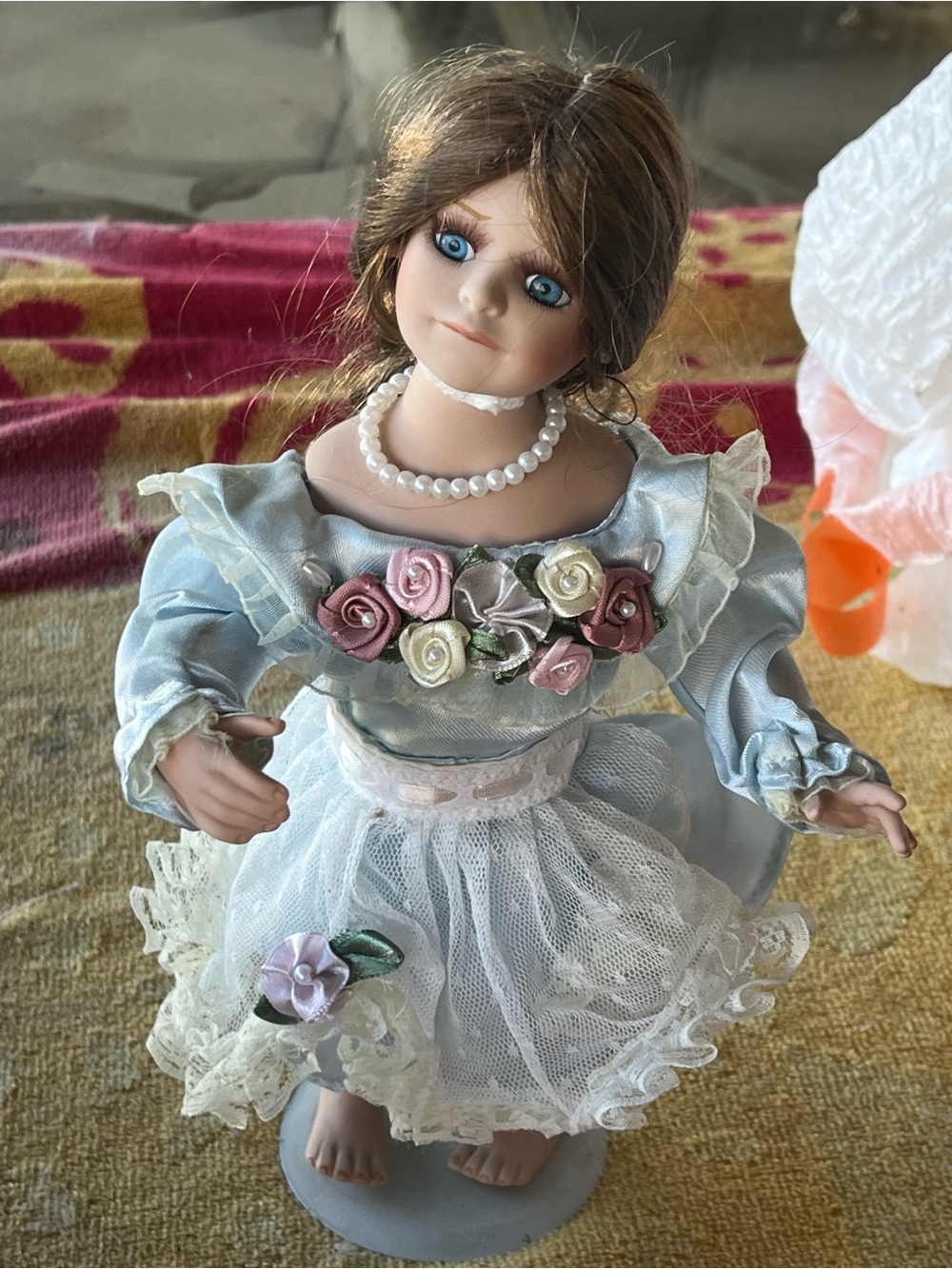 Porcelain Doll in Light Blue Dress with Floral Accents